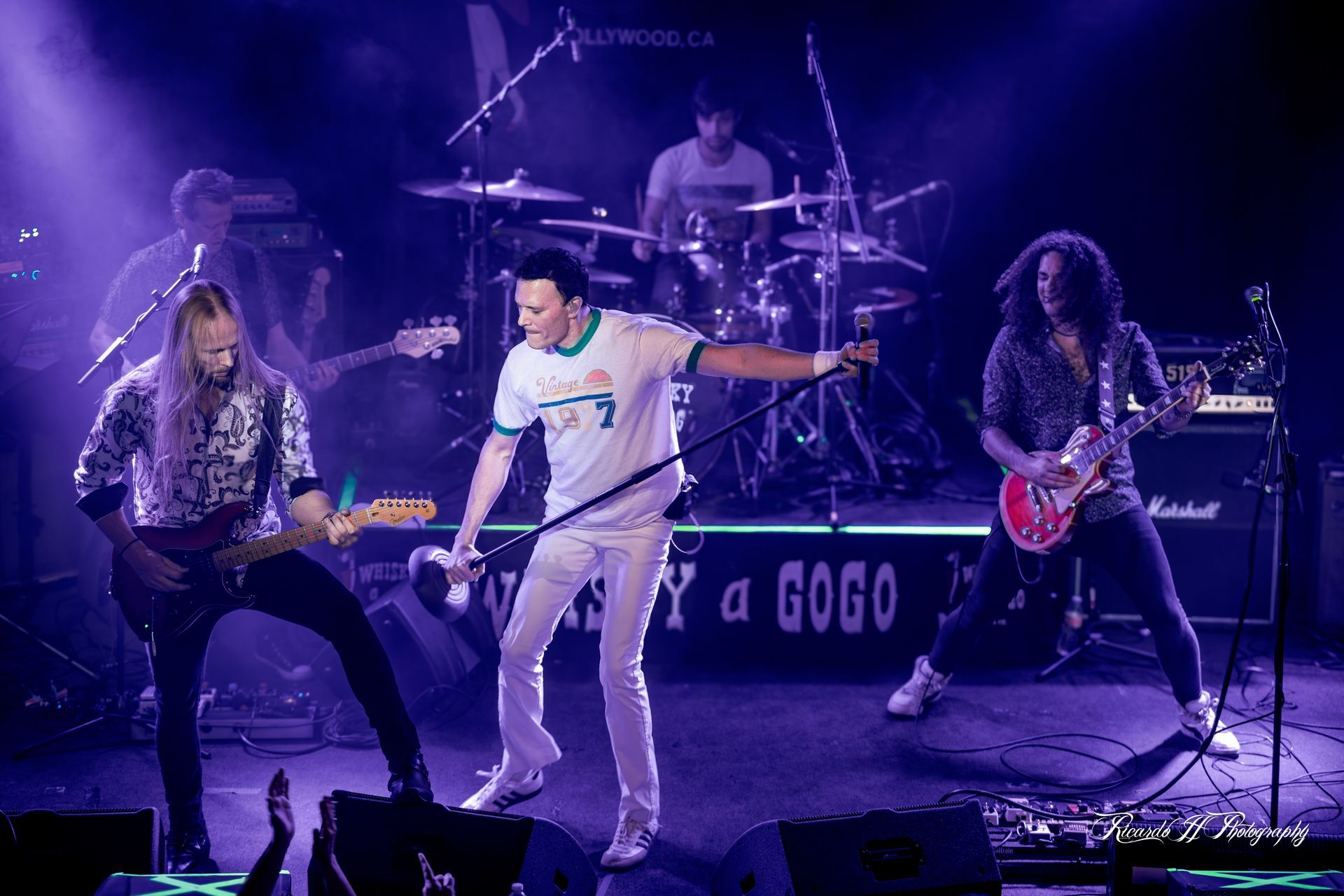 A group of men are playing instruments on a stage.