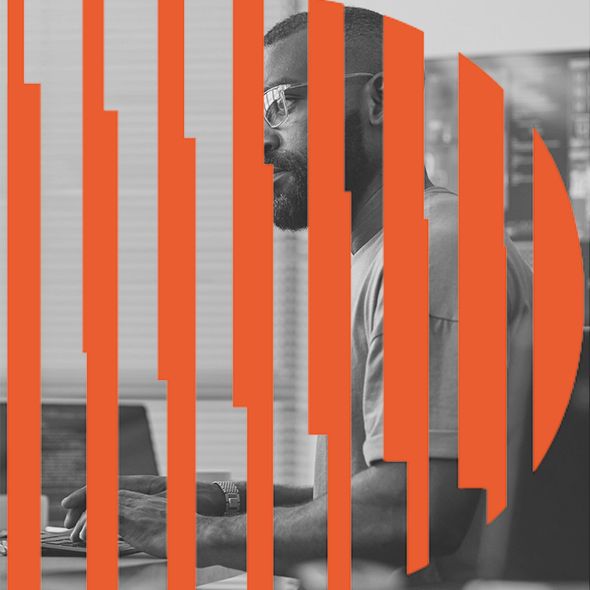 Man with glasses working on a laptop, orange striped overlay.