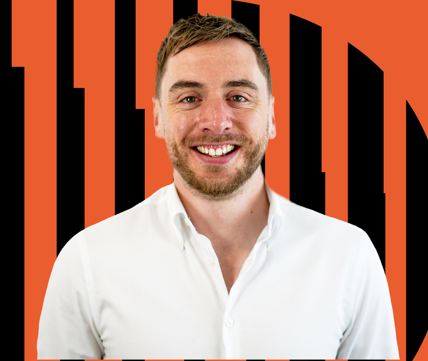 Man smiling, wearing a white shirt, in front of a black and orange geometric background.