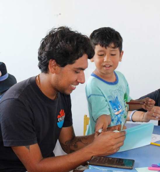 Picture of a volunteer and a child working together.