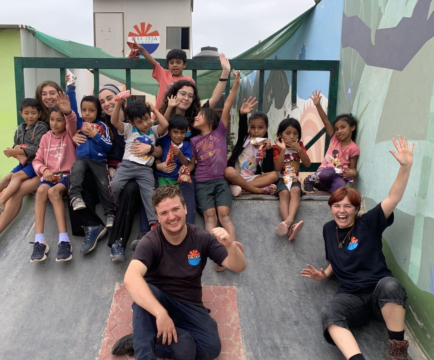 Picture of volunteers and children celebrating at our skate ramp.