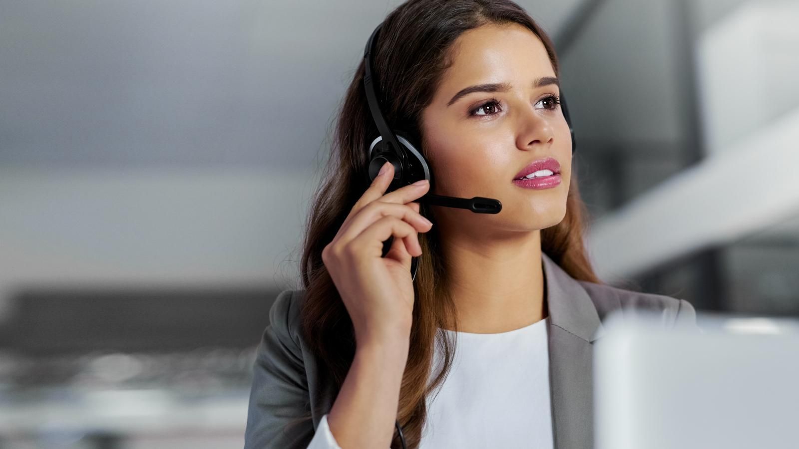 overflow reception service A virtual receptionist is wearing a headset while scheduling an appointment for a patient.