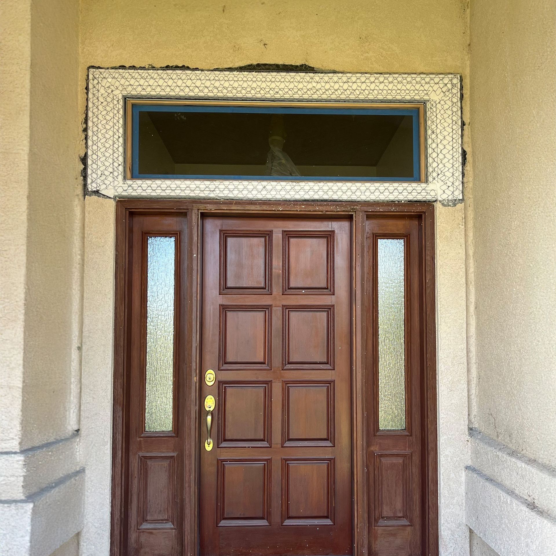 Stucco patch repair above a front door in Reno, Nevada.