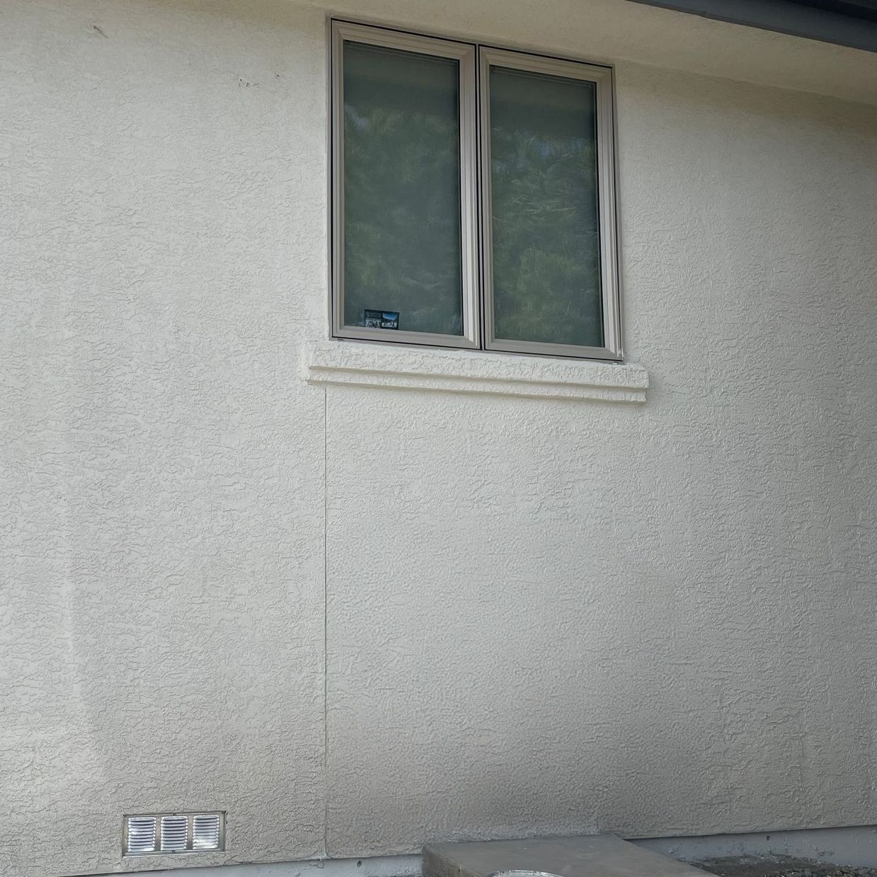 Stucco crack repair under a window in Reno, Nevada.