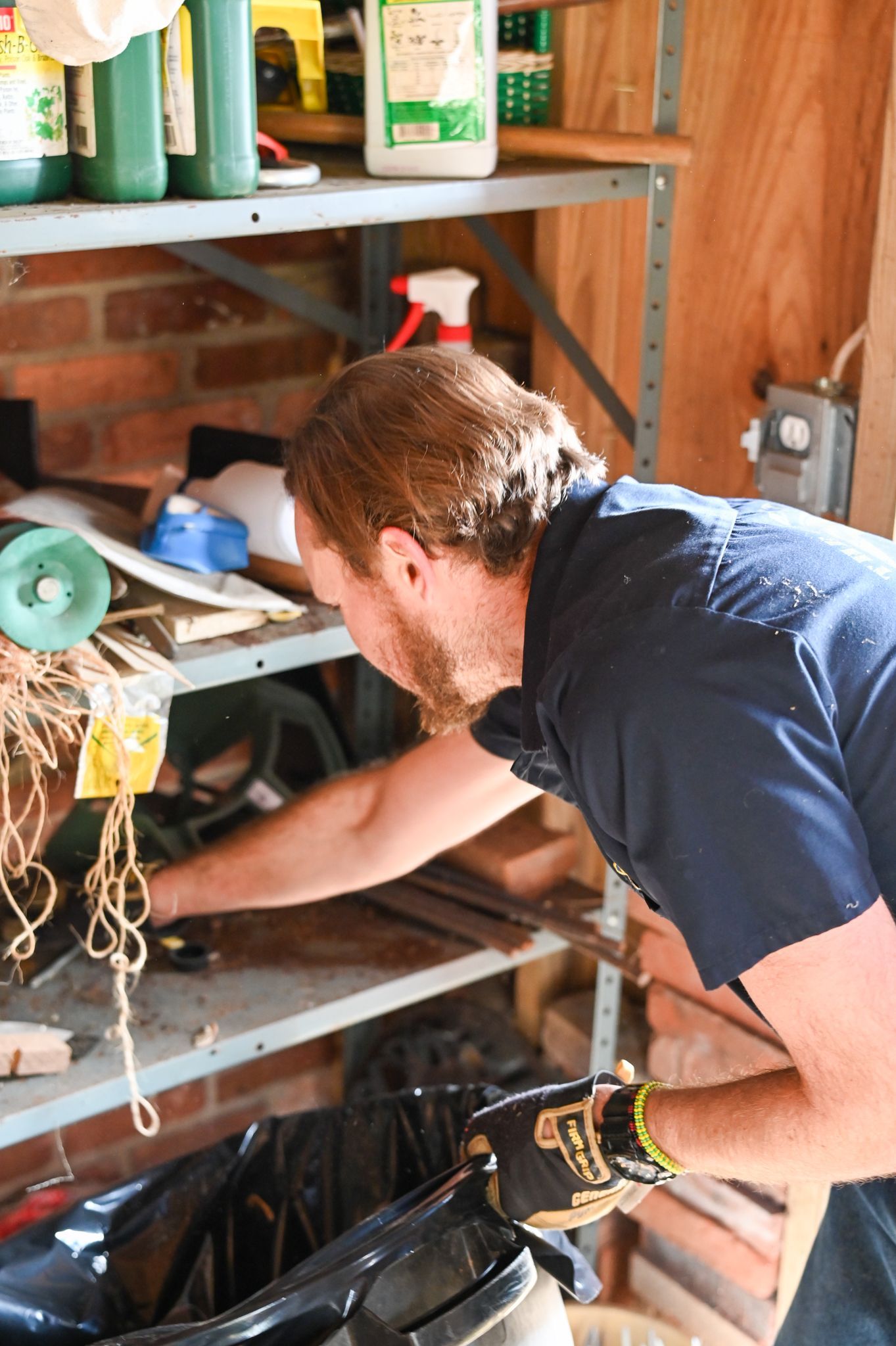 A man is working on a machine in a garage.