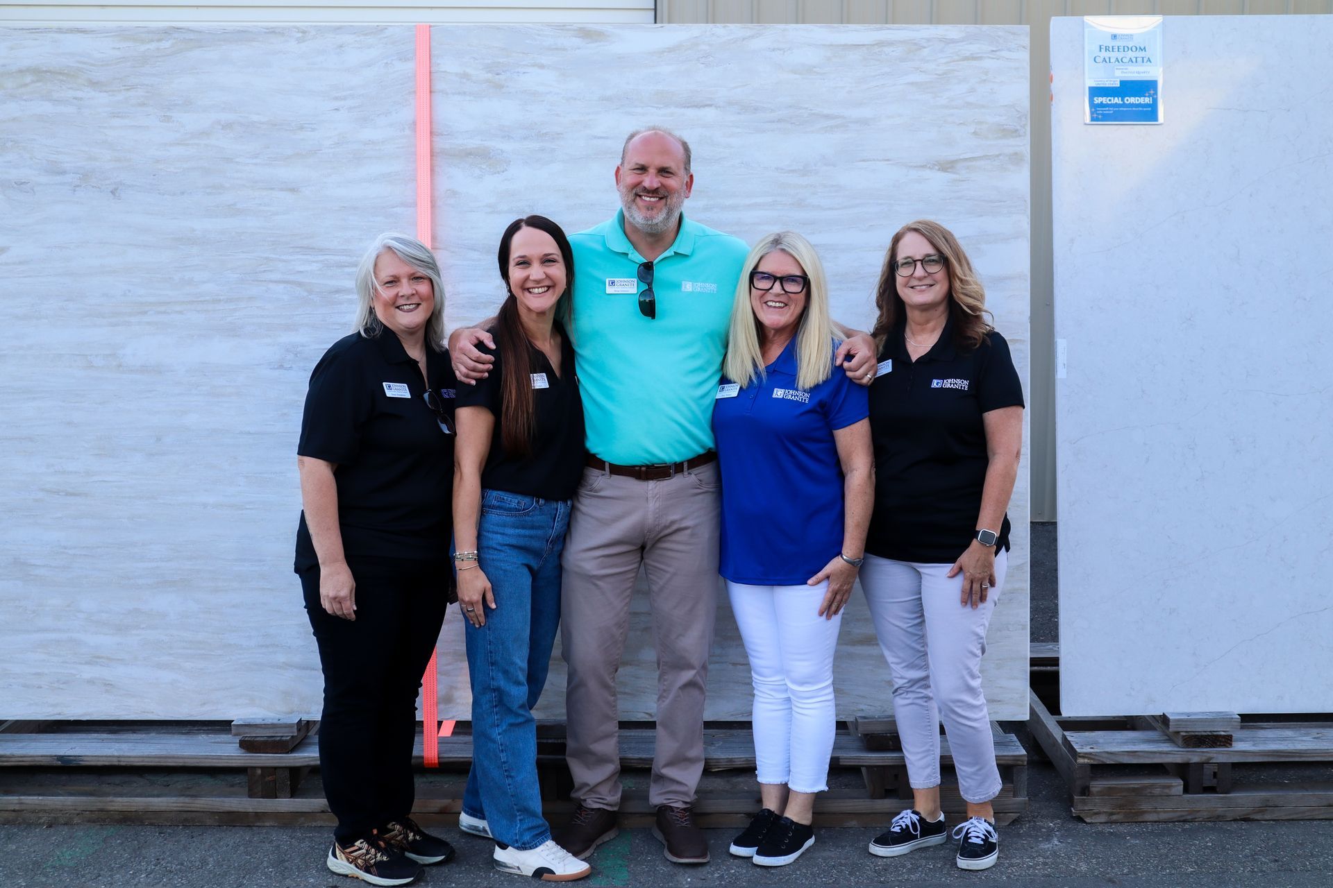 Company President Brian Johnson standing together in front of a white wall outdoors