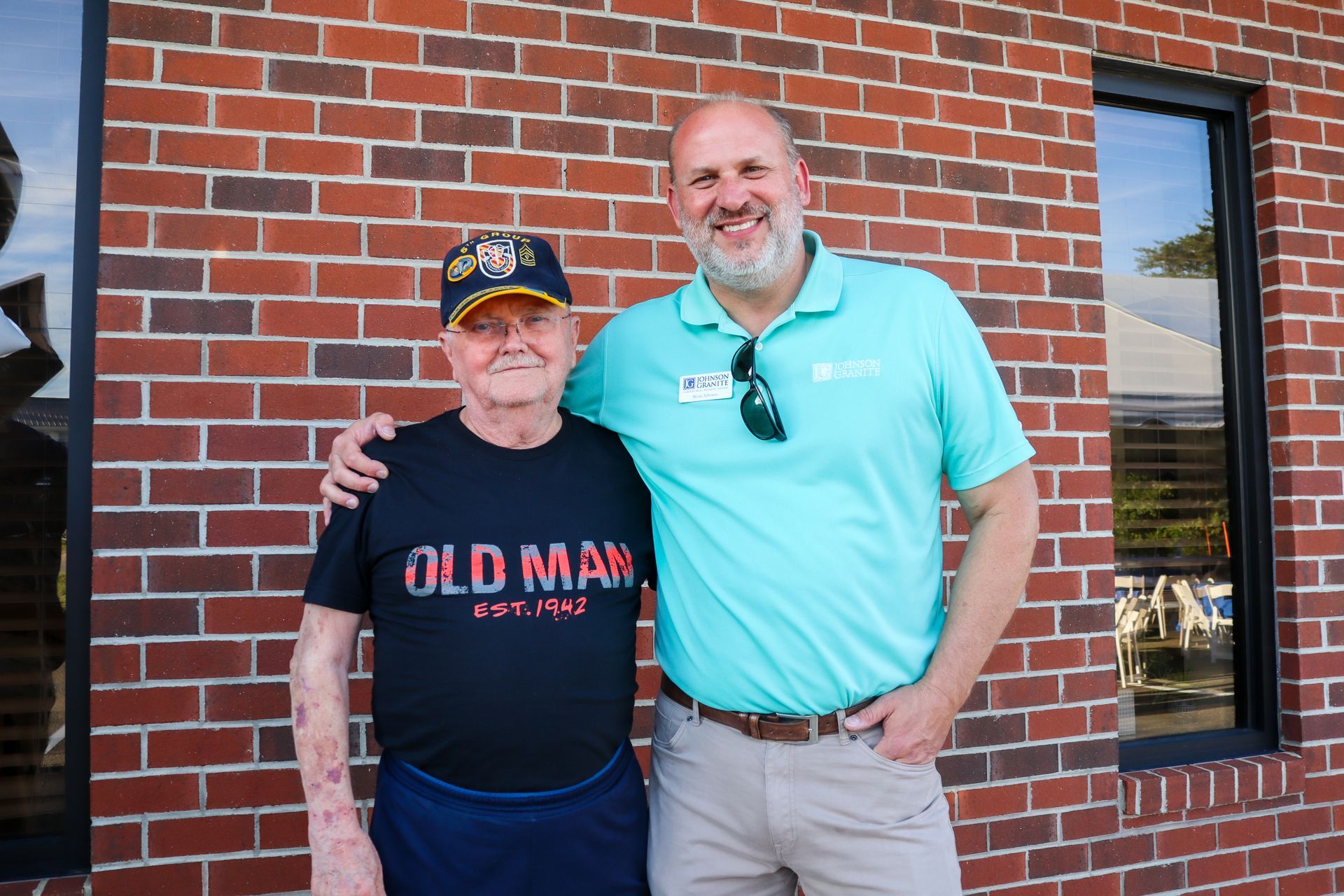 President Brian Johnson standing with a longtime JGI employee