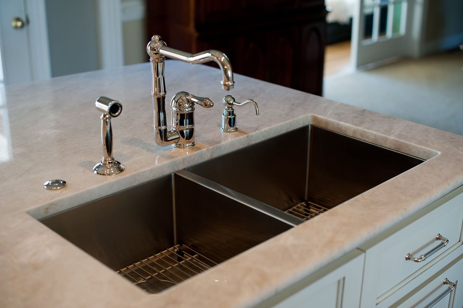 Double-basin kitchen sink with chrome faucet and gray countertop