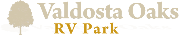 Logo for Valdosta Oaks RV Park, featuring a stylized tree and the park's name.