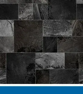 Black slate tile wall with irregular rectangular and square tiles.