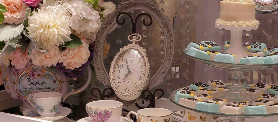 Alice in Wonderland-themed tea table and desserts. Eat ME tea cakes