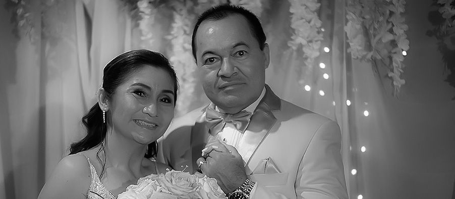 A black and white photo of a bride and groom posing for a picture.
