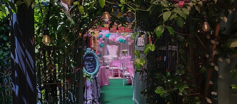 Looking through the gate into bexx secret garden and pretty pink bridal shower.
