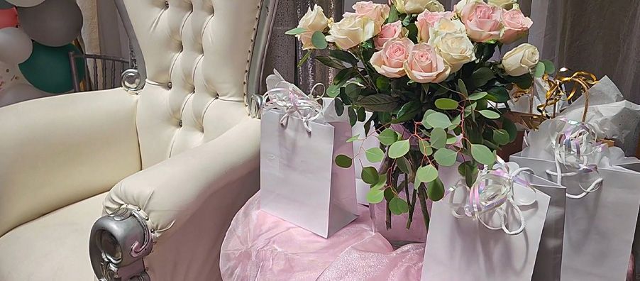 white throne chair with flowers and gifts at bexx secret garden 