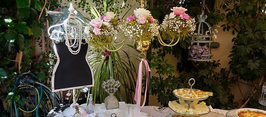 Paris tea party buffet with hanging flower chandelier chalkboard sign with pearls and flowers at bexx secret garden
