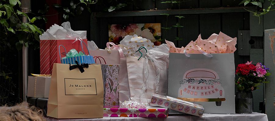 A table topped with lots of gifts and bags.