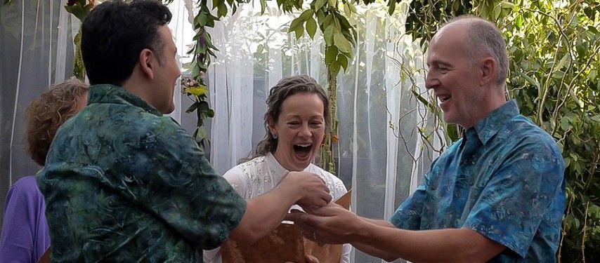 A group of people are standing next to each other and laughing.