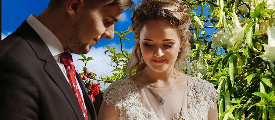 A bride and groom are standing next to each other at their wedding ceremony.