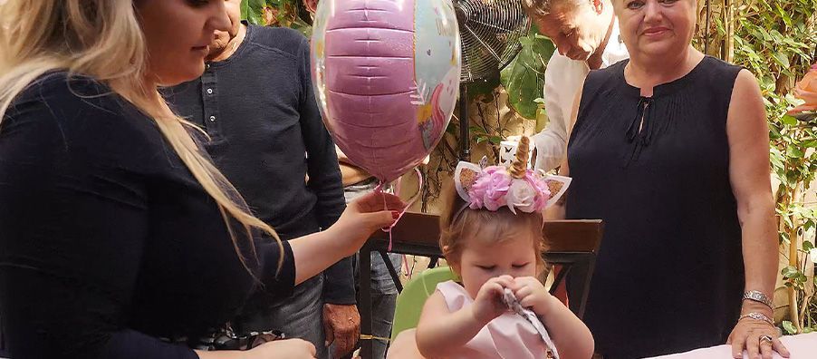 Baby's first unicorn themed birthday. baby with unicorn horn and flower band on her head at bexx secret garden 