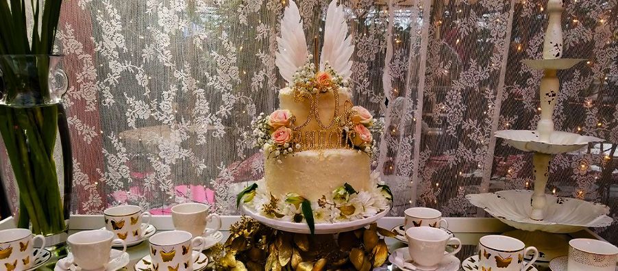 Angel 50th birthday cake with wings and fresh flowers made by bexx secret garden