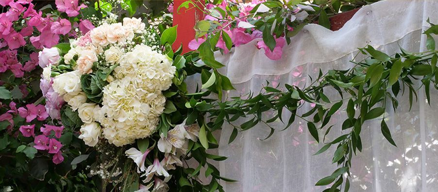 A bunch of flowers are sitting on top of a white curtain.