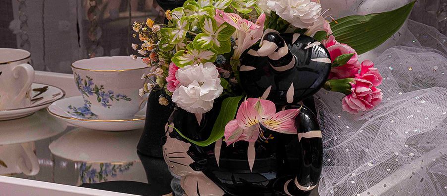 Cheshire cat teapot flower arrangement on Alice in Wonderland Tea table.