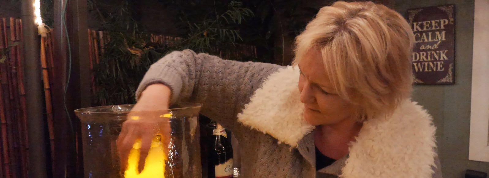 Bexx behind bar setting up a candle making cocktails