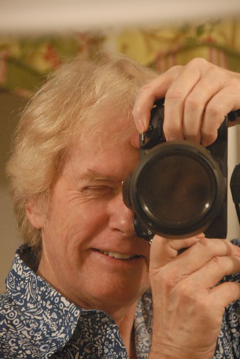 A man is taking a picture of himself with a camera.