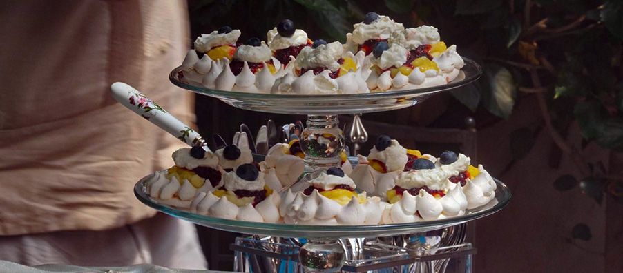 A stack of three plates of meringue with a spoon on top of them.