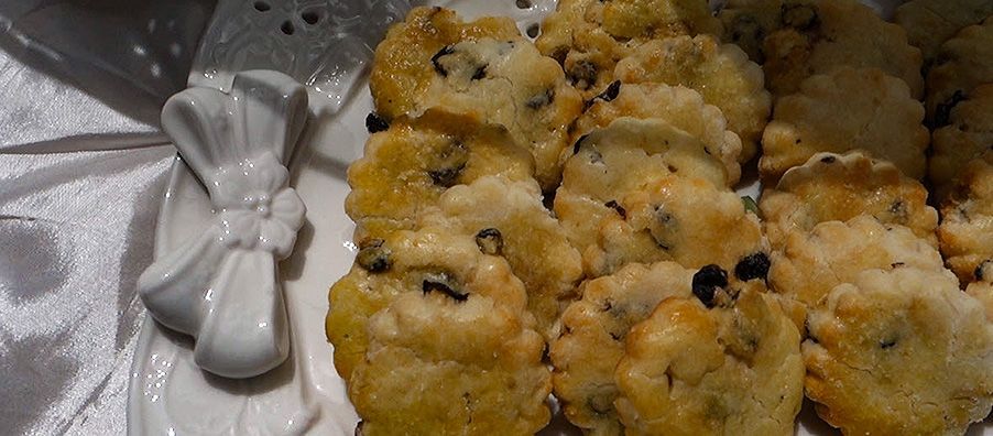 A white plate topped with cookies and a bow on a table.