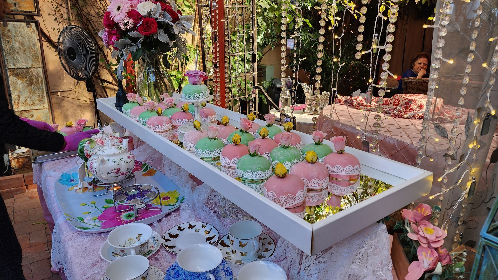 A table with a lot of cupcakes and cups on it.