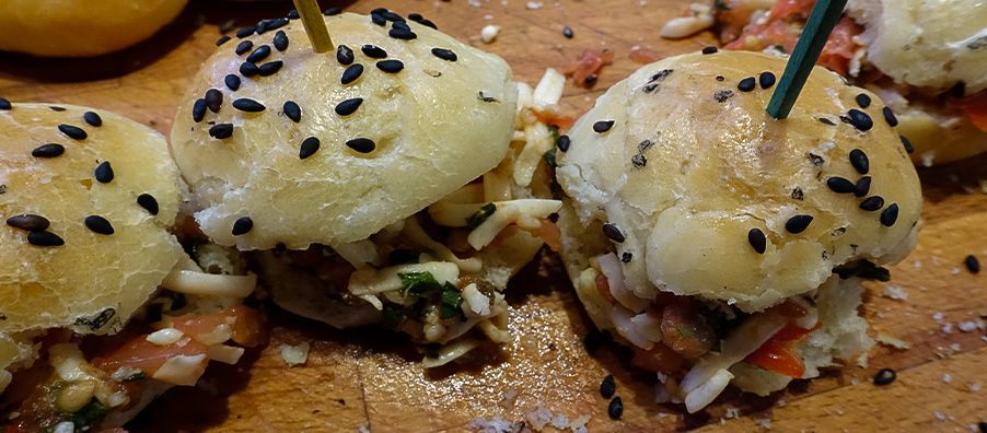 Bruschetta slider made with sesame house-made mini buns, mozzarella, fresh tomatoes olive oil and balsamic glaze. 