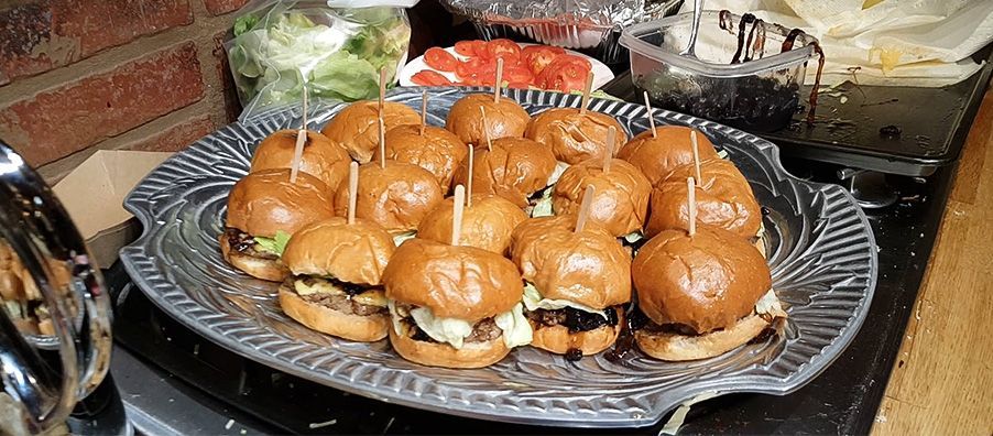 Mini beef sliders with balsamic onions cheese and lettuce.
