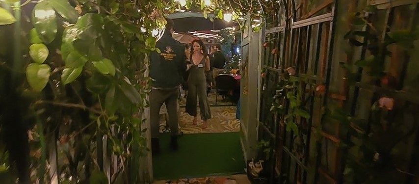 Looking int to the garden gate at an evening party in bexx secret garden