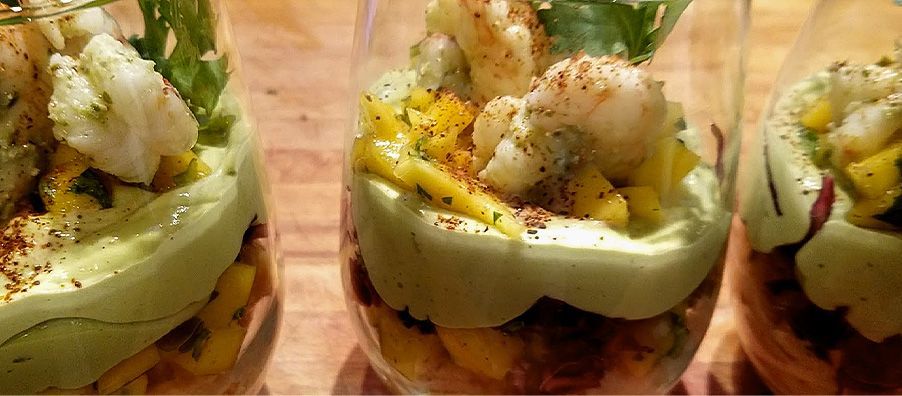 Mango and shrimp cocktail with fresh mango and roasted shrimp on top of guacamole mousse.