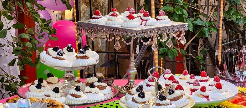 A table topped with a variety of desserts and cupcakes.