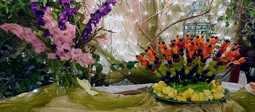 Rainbow Fruit Skewers on table in bexx secret garden