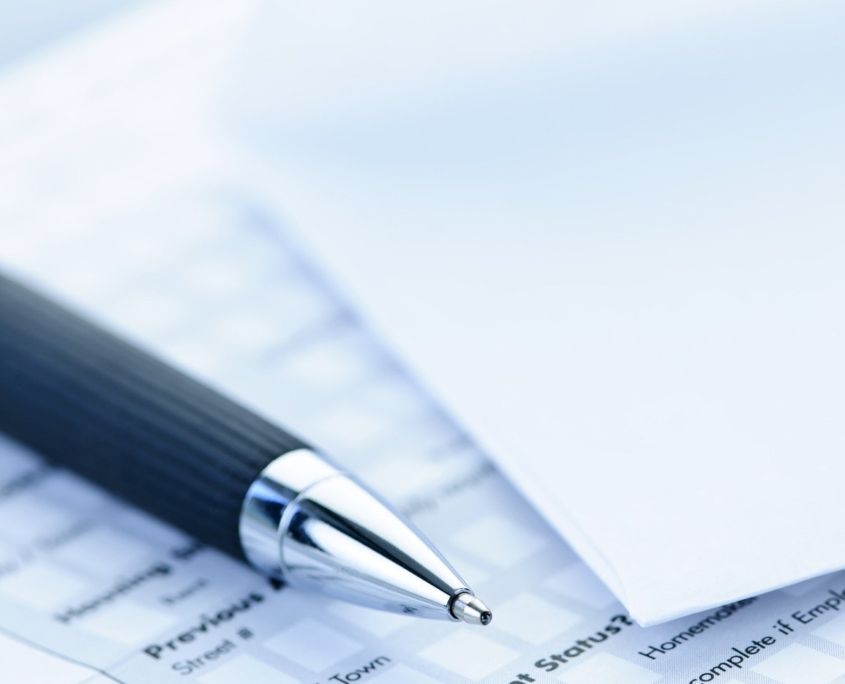 A pen is sitting on top of a piece of paper
