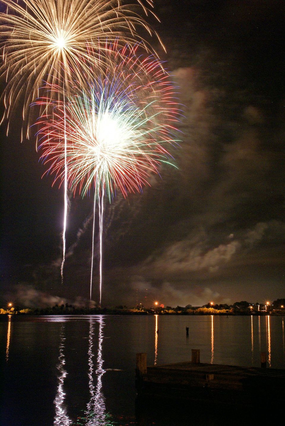 Fireworks are displayed over a body of water