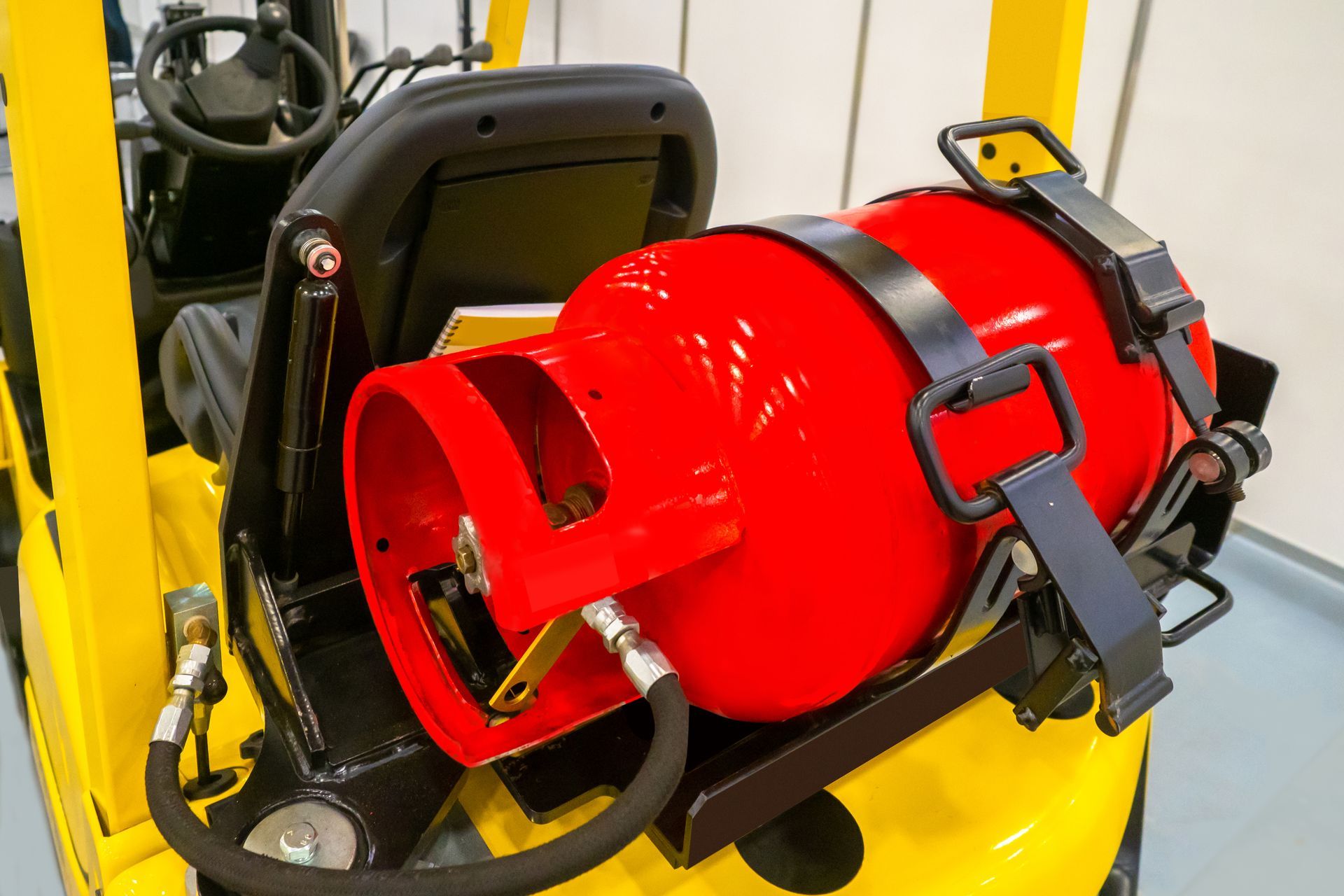 Close-up of a car engine with black and yellow components, including hoses and a dipstick.