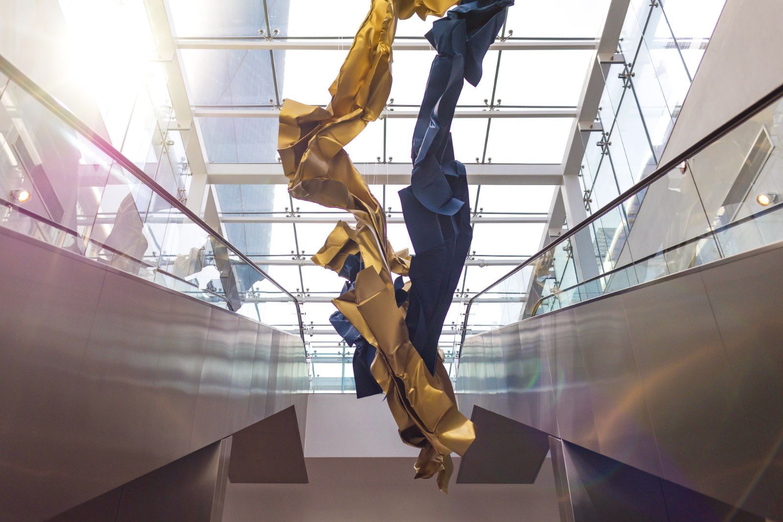 View from beneath Nuage, revealing the flowing sculptural form suspended above the atrium