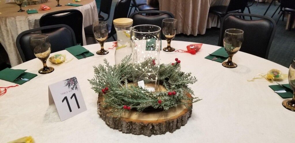 Banquet table with white cloth, floral centerpiece, candle holders, and table number 71