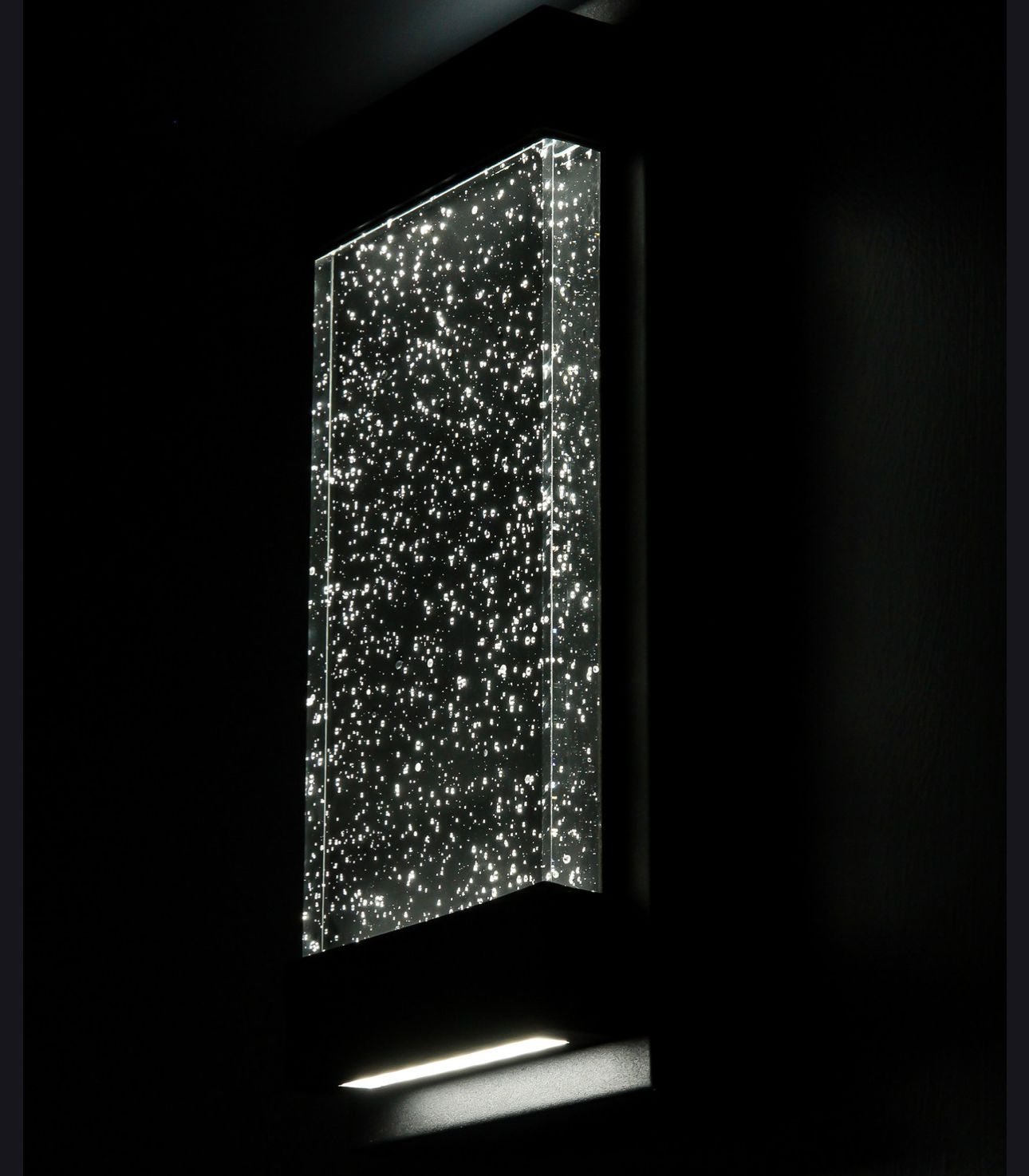 Abstract illuminated glass panel with sparkling white lights against a dark background