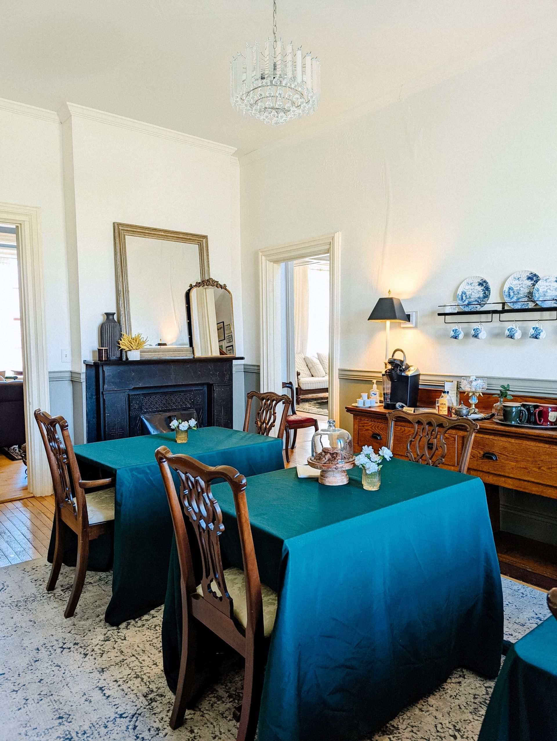 A dining room with tables and chairs and a fireplace