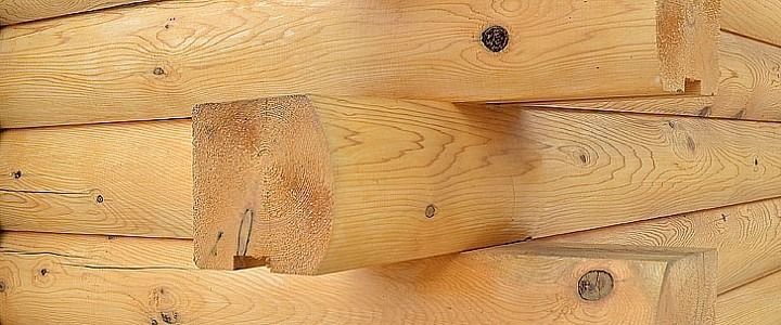 Close-up of light-colored wooden planks with visible knots and grain.
