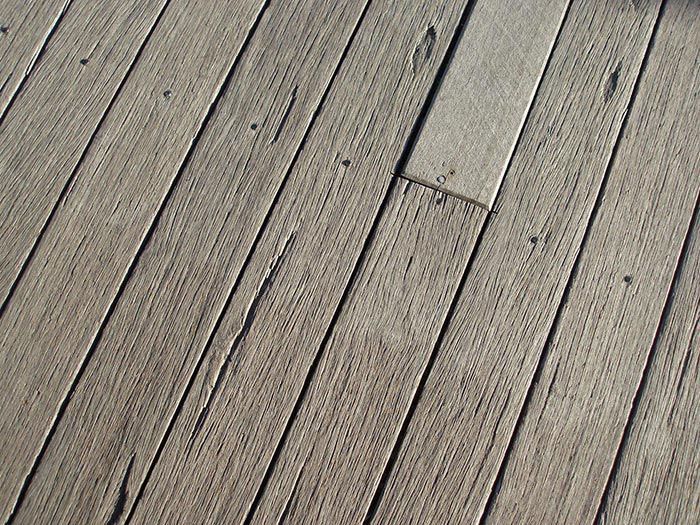 A close up of a wooden deck with a diagonal pattern
