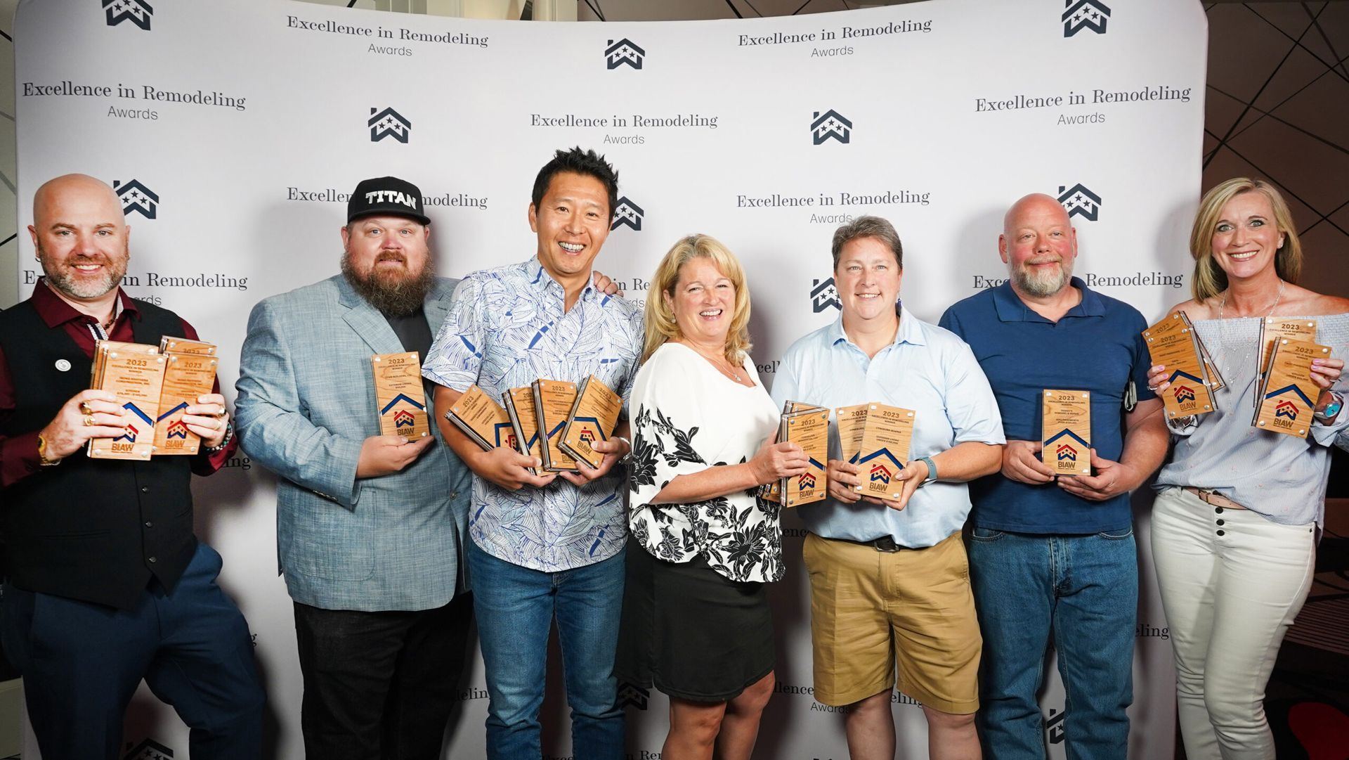 A group of people are standing next to each other holding awards.