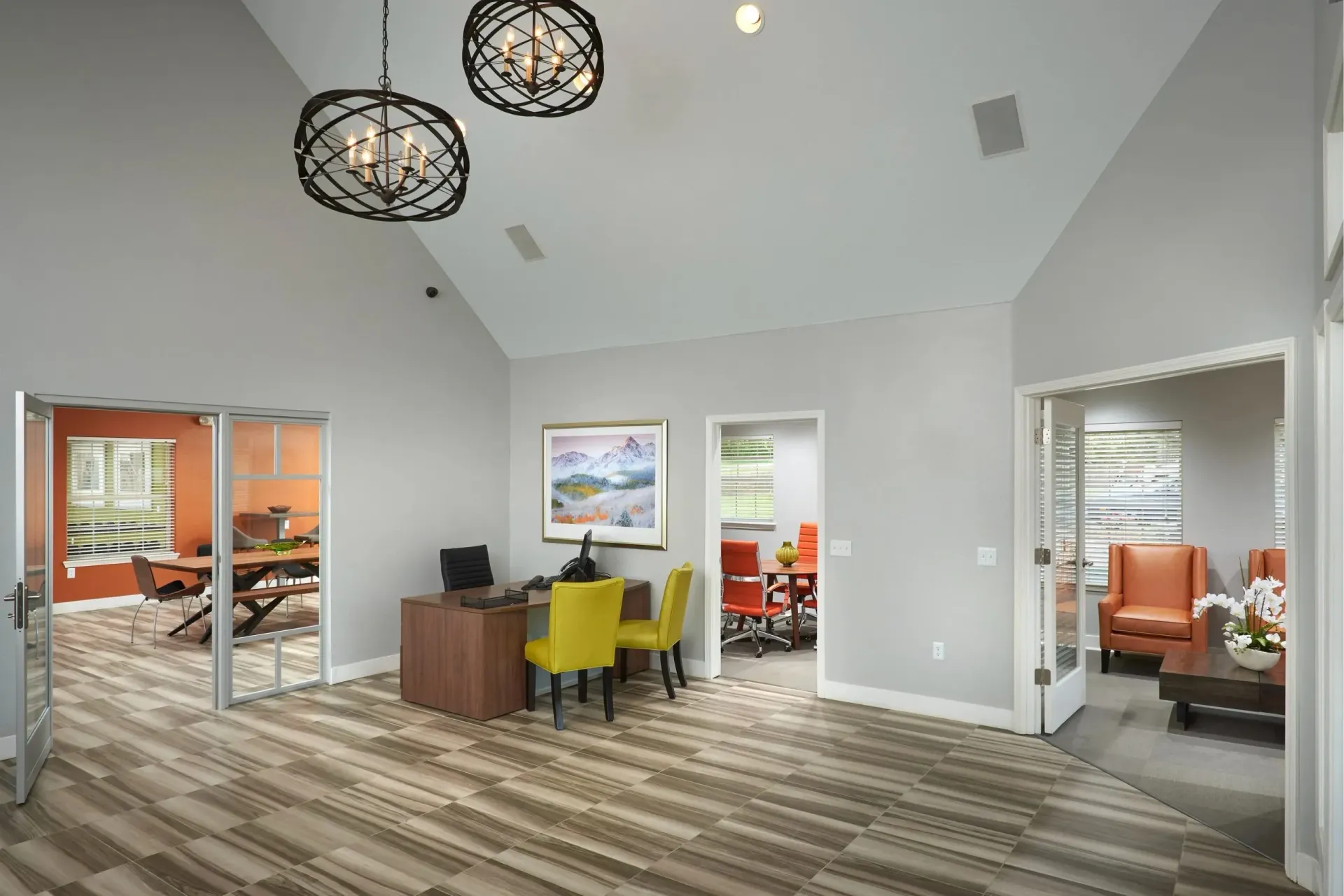 Reception desk with two chairs, leading to a conference room and lounge area.