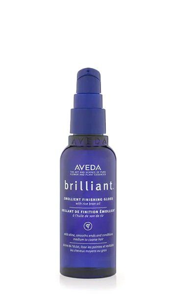 Un flacone alto di plastica blu scuro con dosatore a pompa di pomata idratante Aveda Brilliant, su sfondo bianco.
