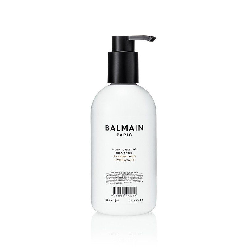 Una bottiglia bianca di shampoo idratante Balmain Paris con dosatore a pompa nero su sfondo bianco.